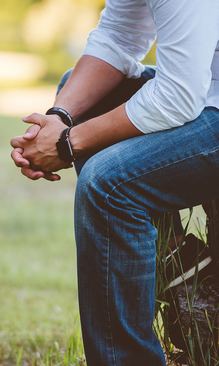 a man with hands folded in prayer
