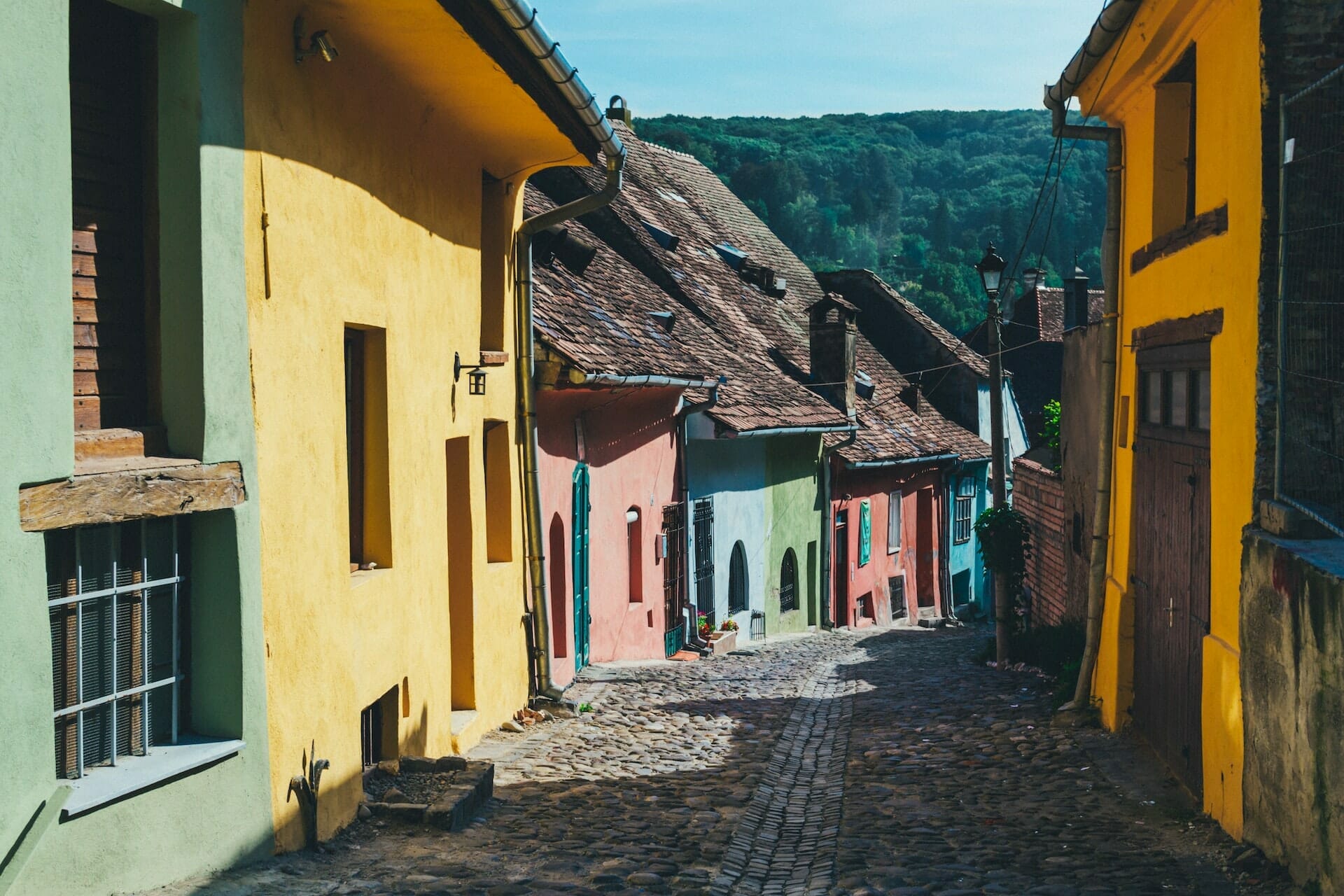 In this article, Robert Norman explores legalism and unhelpful traditions in Romania. This image pictures a Romanian village with colorful houses throughout the street.